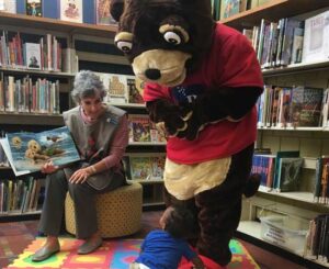 Ripple the otter makes an appearance at a children's story time