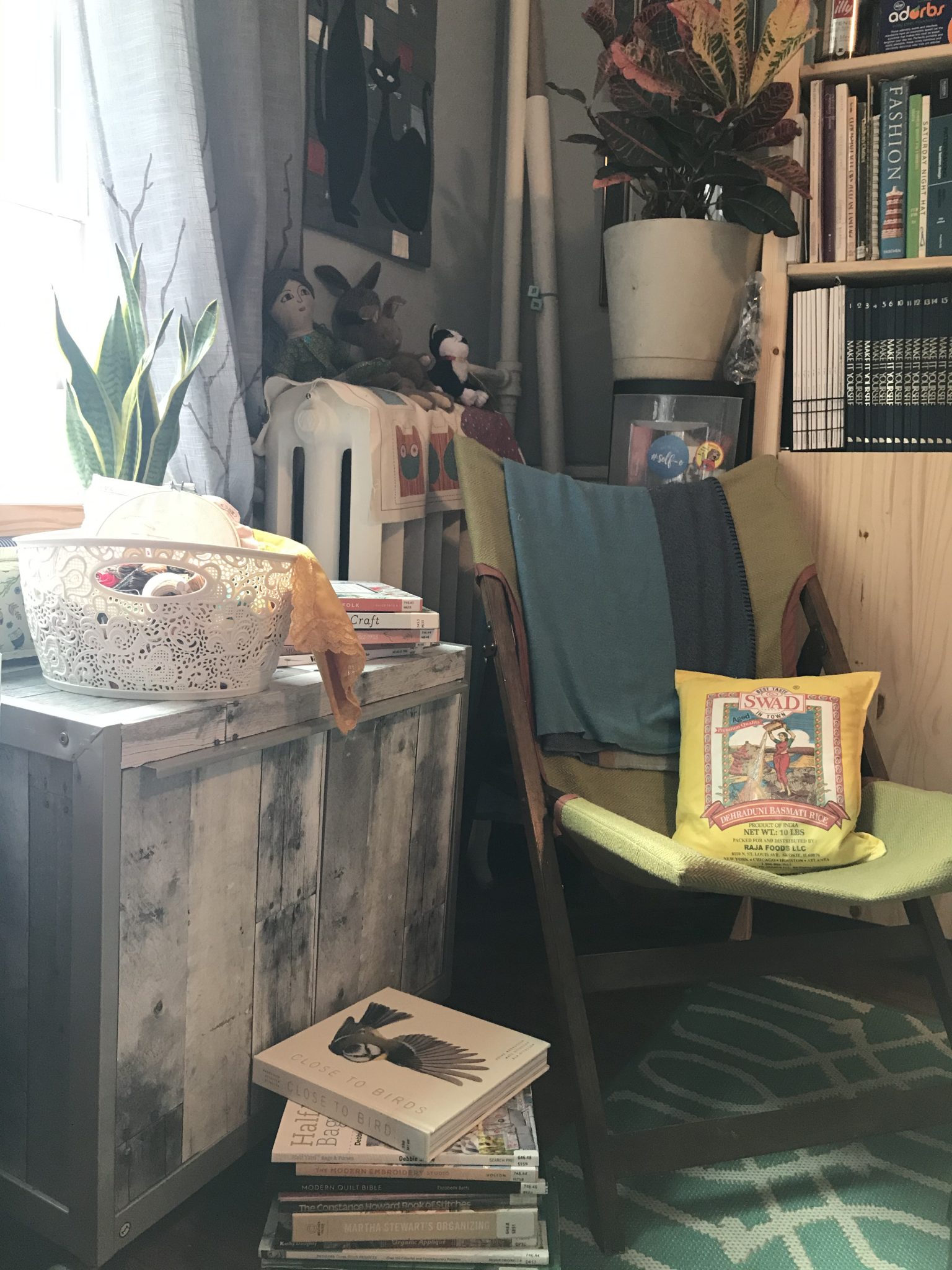chair with books and embroidery basket