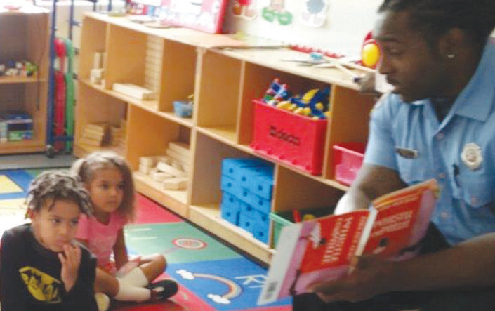 Volunteer Reading a book to children