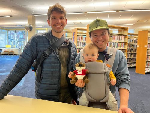 couple brings their toddler to the library