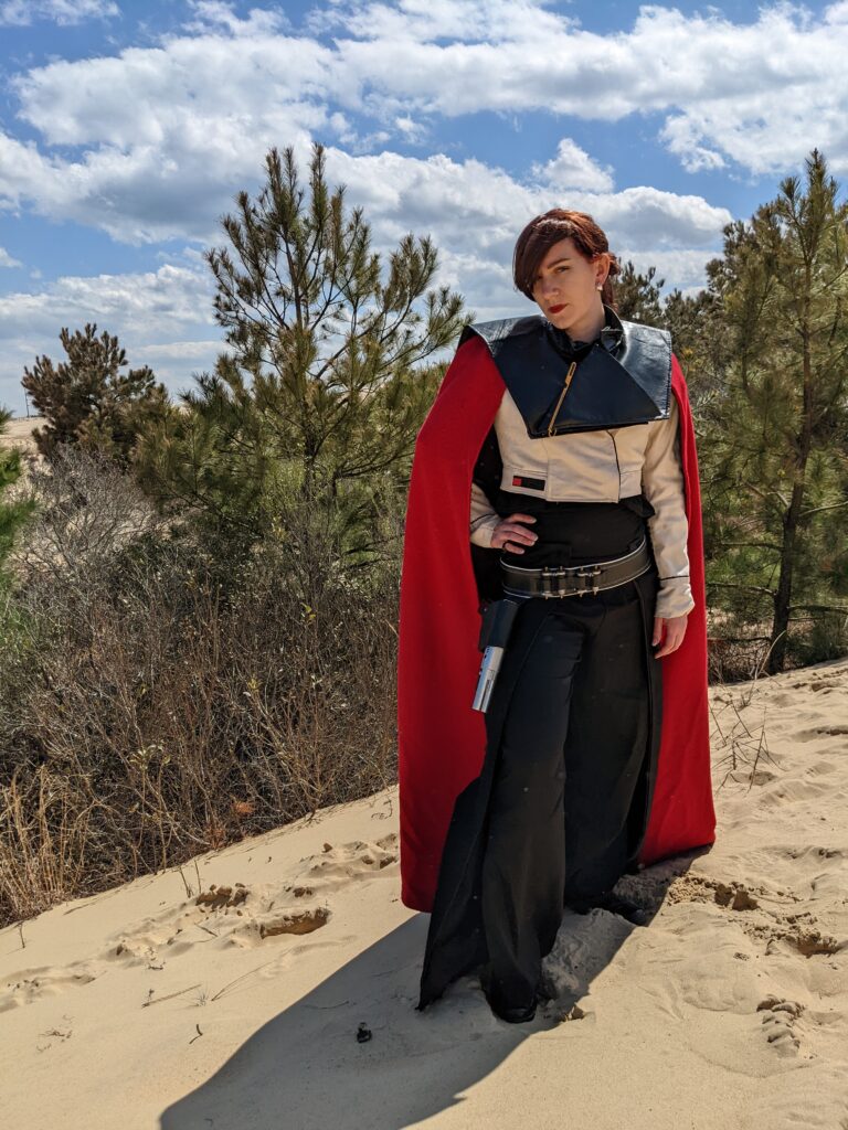 Me standing on a sand dune dressed as Qi'ra from Solo: A Star Wars Story.