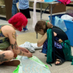 Costume Making Two people working on a costume