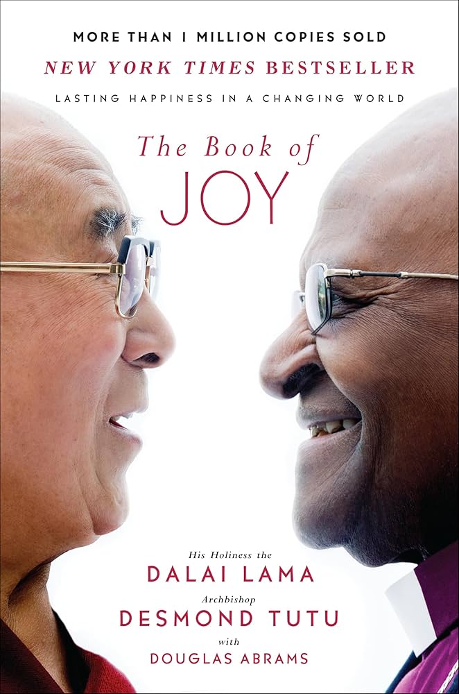 Book cover for "The Book of Joy" by Dalai Lama and Desmond Tutu featuring the two authors in profile facing each other and smiling.