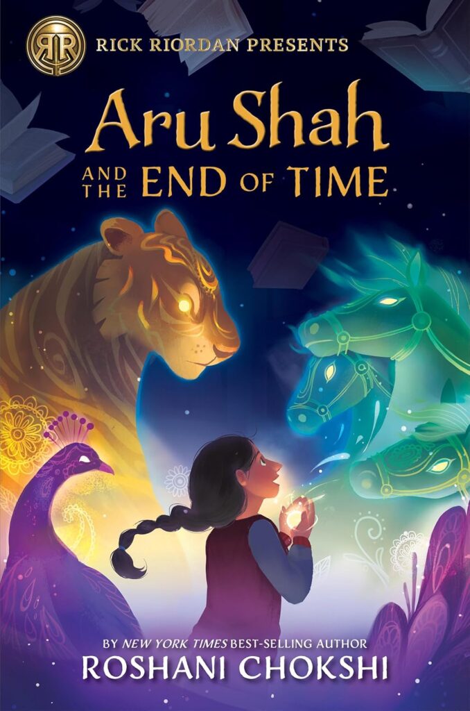 Book cover for Aru Shah and the End of Time by Roshani Chokshi. On the cover a girl gazes at glowing, ethereal figures: a tiger, a peacock, and two horses, against a starry night sky.